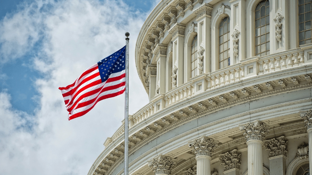 Flag of The United States with the Capitol Building in the background