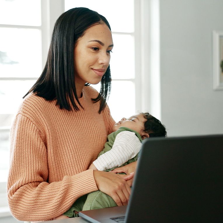 Woman with child looking at a computer